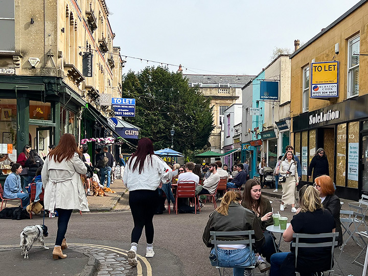 Clifton village over the weekend showing people dining at the various outdoor coffee shops